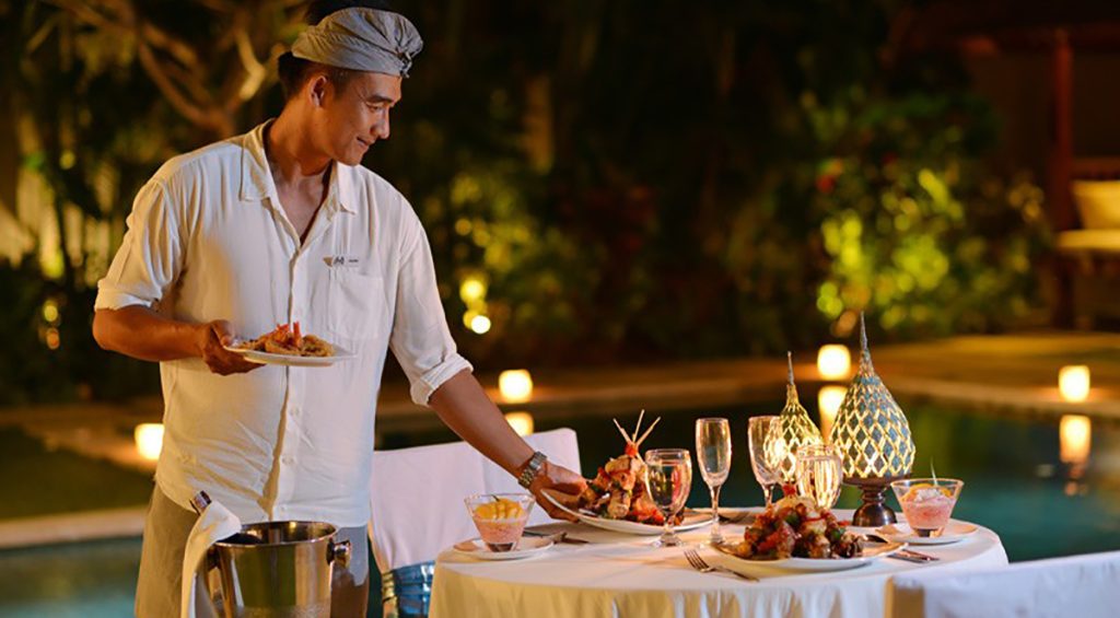 Staff-nyaman-villas-preparing-candle-light-dinner-by-the-pool-bali